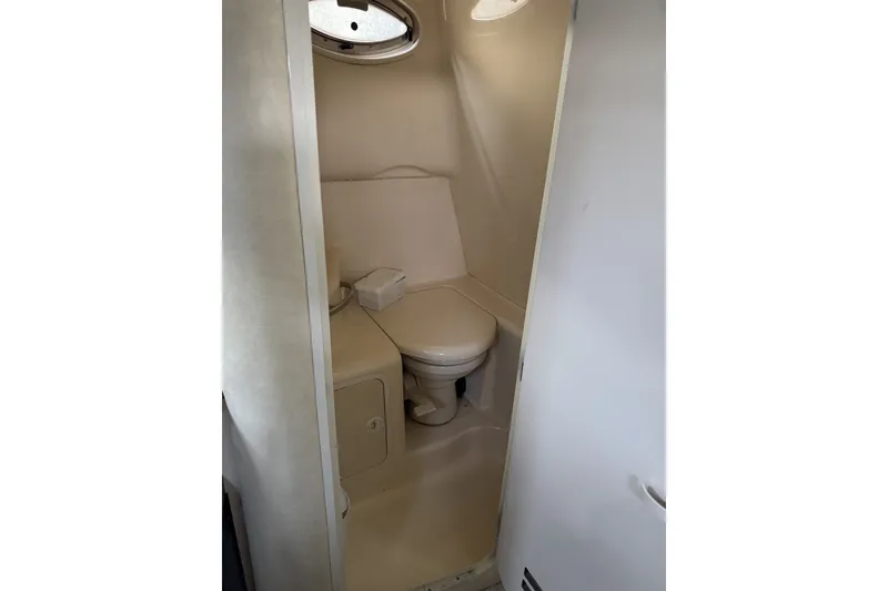 Slide: The Image of Compact bathroom in 2000 Sea Ray 290 Sundancer boat with toilet and storage. - 12