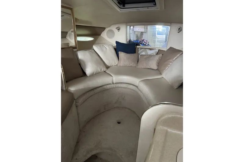 Slide: The Image of Interior of 2000 Sea Ray 290 Sundancer with plush seating and decorative pillows. - 9
