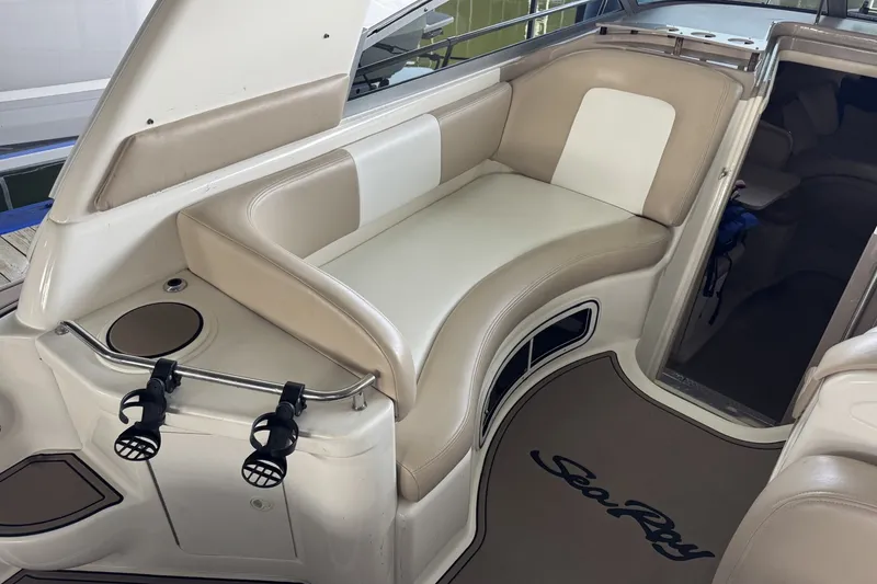 Slide: The Image of Interior of 2000 Sea Ray 290 Sundancer boat with beige seating and cup holders. - 5
