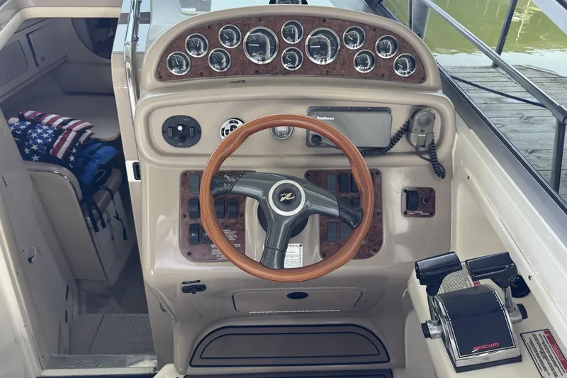 Slide: The Image of 2000 Sea Ray 290 Sundancer helm with wood accents and navigation equipment. - 7
