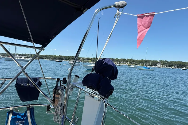 Slide: The Image of Sailing on a 2009 Sabre 386 yacht in a serene harbor with clear blue skies. - 88