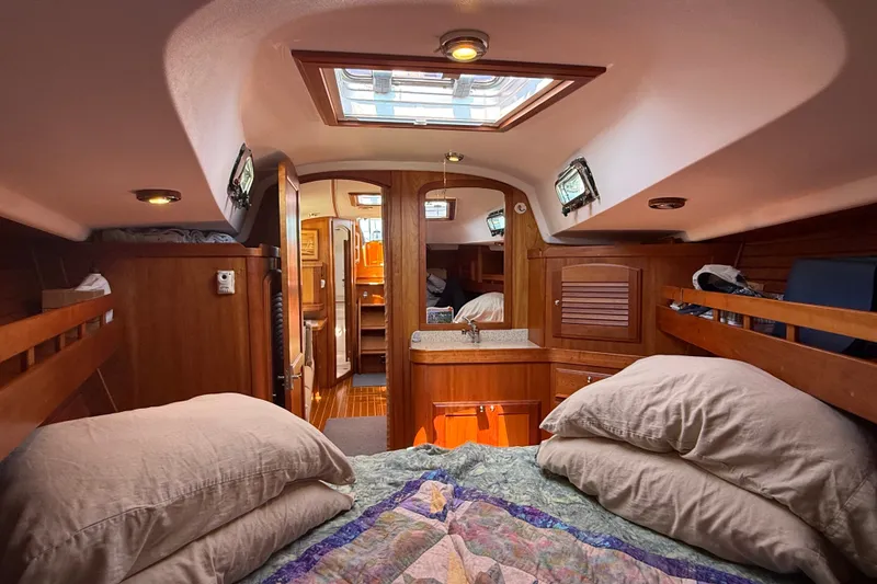 Slide: The Image of Luxurious interior of 2009 Sabre 386 sailboat, featuring cozy cabin with wooden finishes. - 39