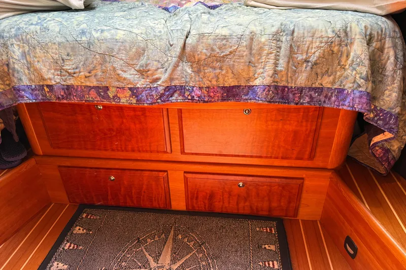 Slide: The Image of Wooden storage drawers under bed with patterned quilt, Sabre 386, 2009 model. - 45