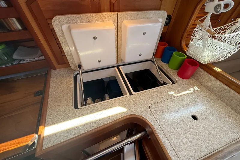 Slide: The Image of 2009 Sabre 386 yacht galley with dual sinks and colorful cup holders. - 27