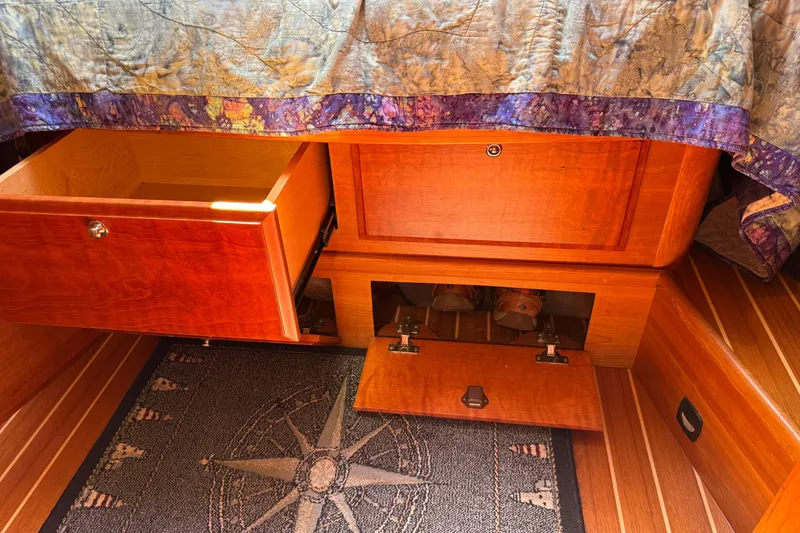 Slide: The Image of Wooden storage drawers and compartments in a 2009 Sabre 386 boat interior. - 46