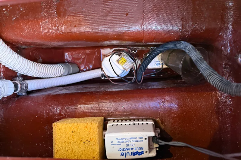 Slide: The Image of Bilge pump system in a 2009 Sabre 386 sailboat with hoses and wiring. - 107