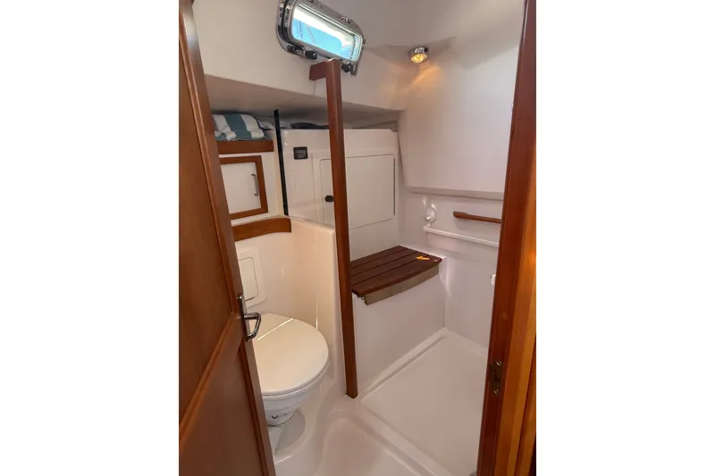 Slide: The Image of 2009 Sabre 386 yacht bathroom with wooden accents and compact design. - 54