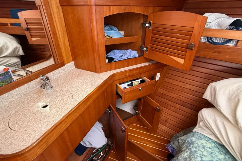 Slide: The Image of Wooden interior of 2009 Sabre 386 yacht with open cabinets and countertop sink. - 43