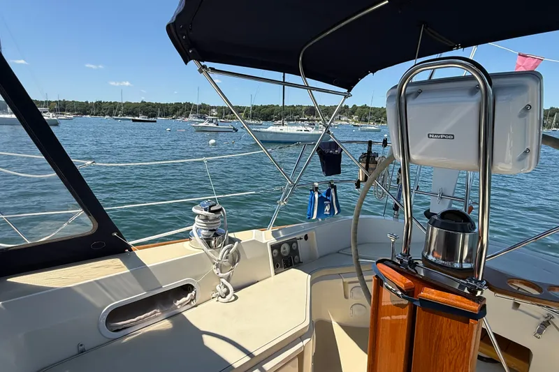Slide: The Image of Cockpit view of 2009 Sabre 386 sailboat with marina backdrop. - 78