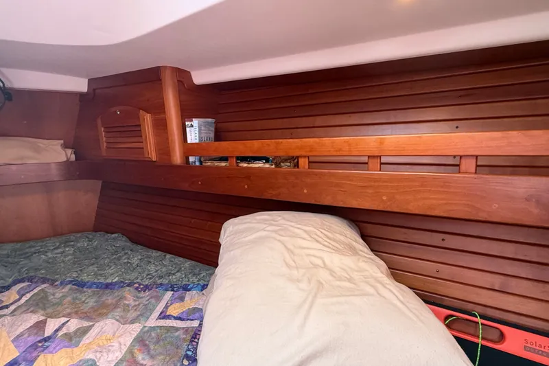 Slide: The Image of Cozy cabin interior of 2009 Sabre 386 sailboat with wooden paneling and bedding. - 40