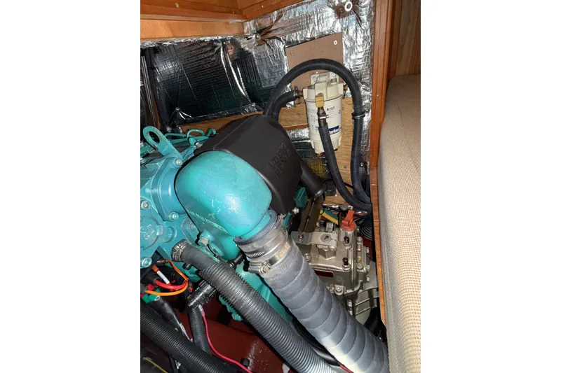 Slide: The Image of Engine compartment of a 2009 Sabre 386 sailboat, featuring mechanical components and wiring. - 99