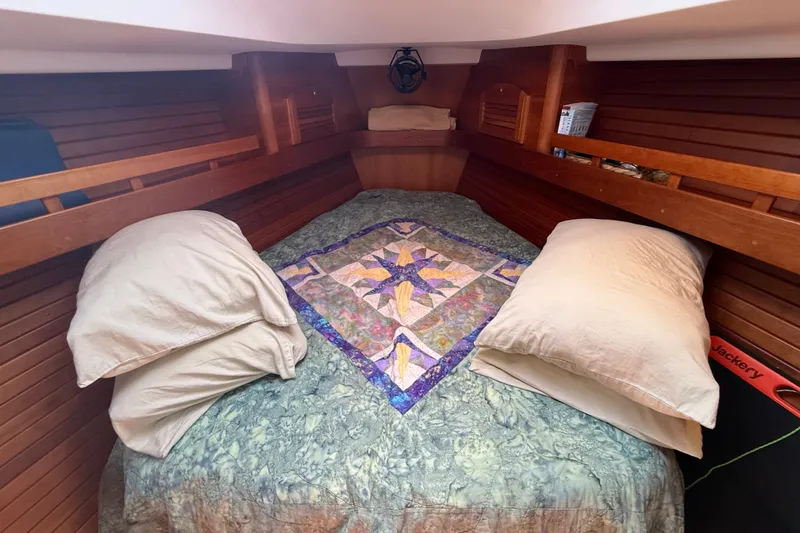 Slide: The Image of Cozy cabin interior of 2009 Sabre 386 sailboat with quilted bedding and wooden paneling. - 37