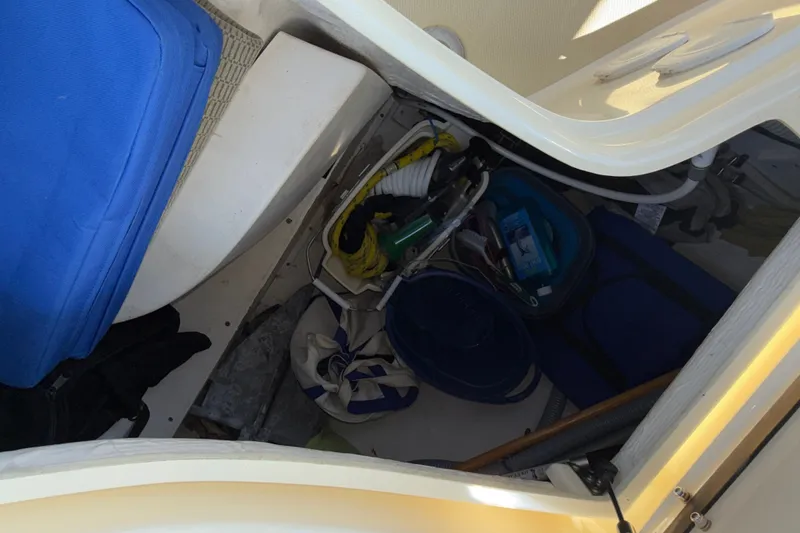 Slide: The Image of Storage compartment on a 2009 Sabre 386 boat with various equipment and supplies. - 90