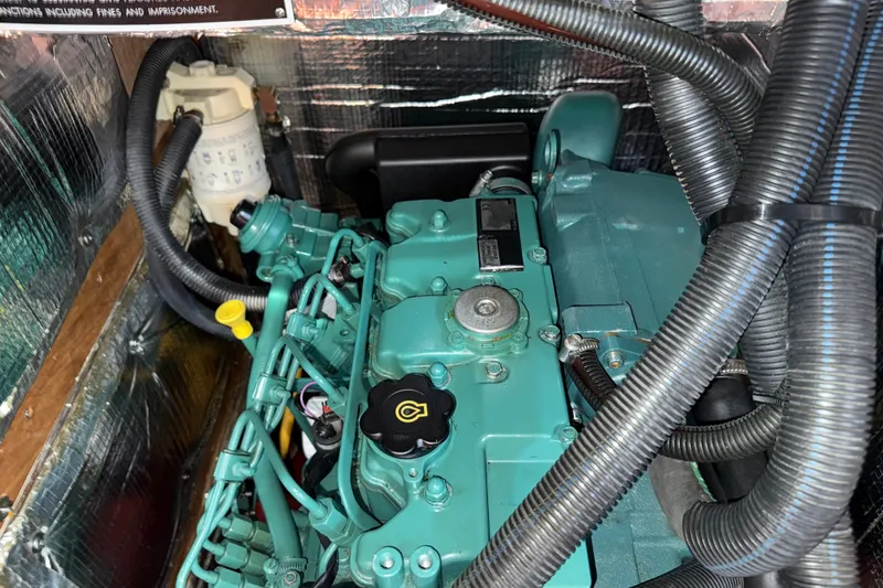 Slide: The Image of Engine compartment of a 2009 Sabre 386, featuring a well-maintained marine engine. - 94