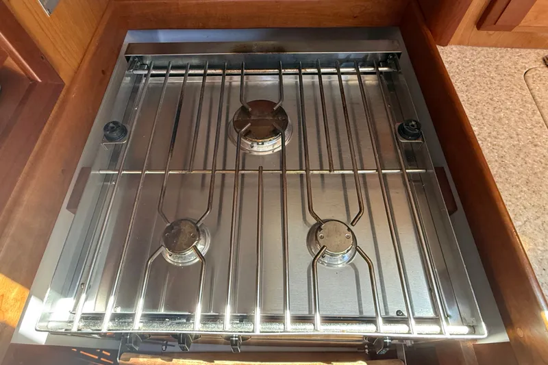 Slide: The Image of Three-burner stainless steel stove in a 2009 Sabre 386 yacht kitchen. - 31