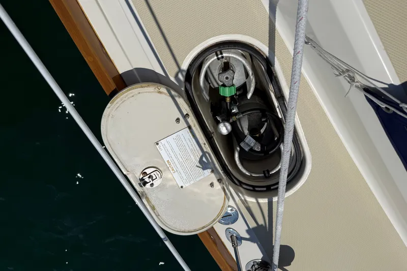 Slide: The Image of Open hatch on 2009 Sabre 386 sailboat deck, revealing propane tank storage. - 86