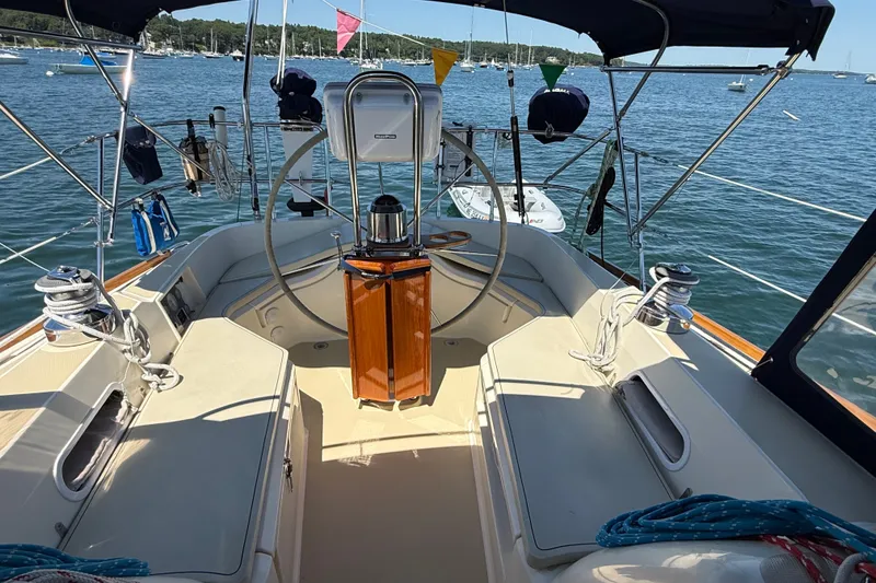 Slide: The Image of Cockpit of 2009 Sabre 386 sailboat with steering wheel, ropes, and ocean view. - 75