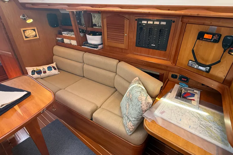 Slide: The Image of Cozy interior of 2009 Sabre 386 sailboat with navigation station and comfortable seating. - 13