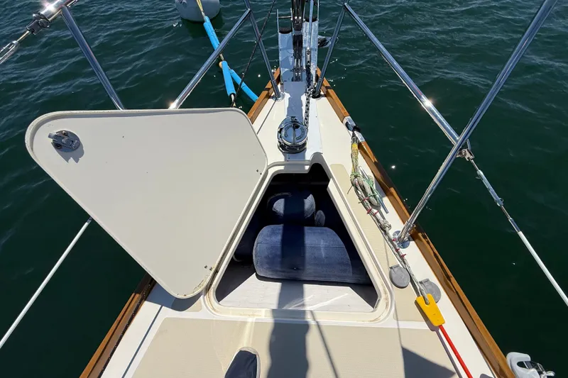 Slide: The Image of Sailboat deck of 2009 Sabre 386 with open hatch, showing interior storage. - 64