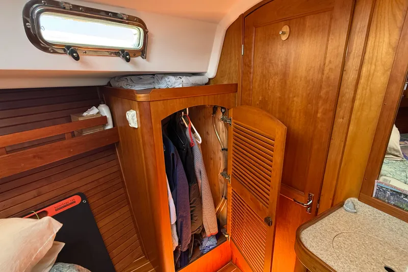 Slide: The Image of Interior of 2009 Sabre 386 sailboat with wooden closet and porthole window. - 44