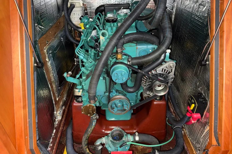 Slide: The Image of Engine compartment of a 2009 Sabre 386 sailboat, featuring a well-maintained marine engine. - 93