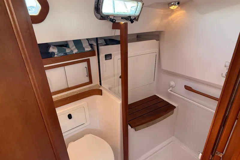 Slide: The Image of 2009 Sabre 386 yacht bathroom with wooden accents and compact design. - 50