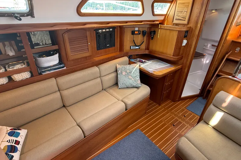 Slide: The Image of Interior of 2009 Sabre 386 sailboat with cozy seating and wooden cabinetry. - 15