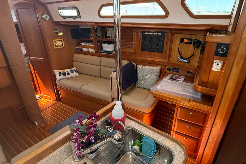 Slide: The Image of Interior of 2009 Sabre 386 sailboat with cozy seating and wooden cabinetry. - 25