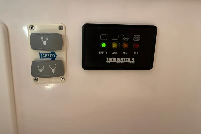 Slide: The Image of Control panel with Jabsco switches and TankWatch 4 level monitor on Sabre 386, 2009 model. - 57