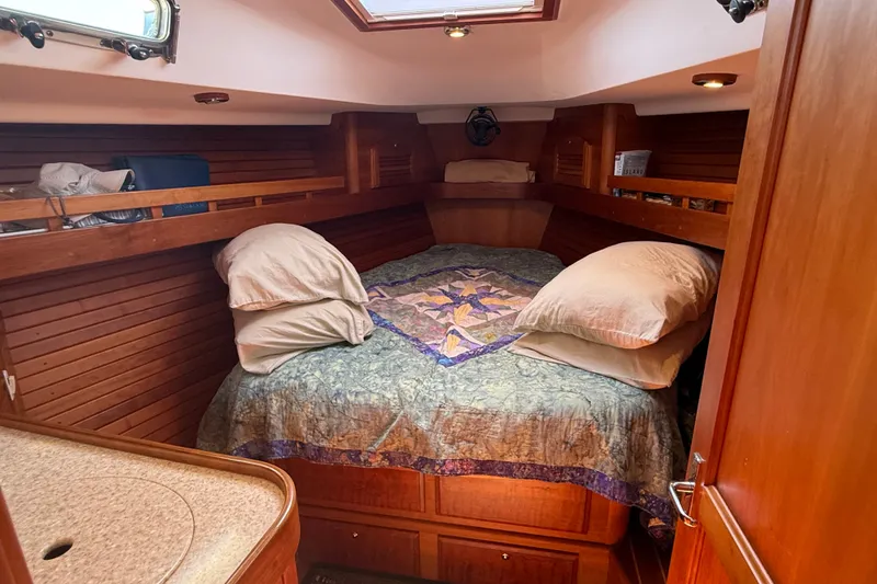 Slide: The Image of Cozy cabin interior of 2009 Sabre 386 sailboat with wooden paneling and comfortable bedding. - 36