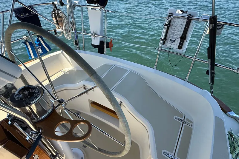 Slide: The Image of Steering wheel and cockpit of a 2009 Sabre 386 sailboat on the water. - 80