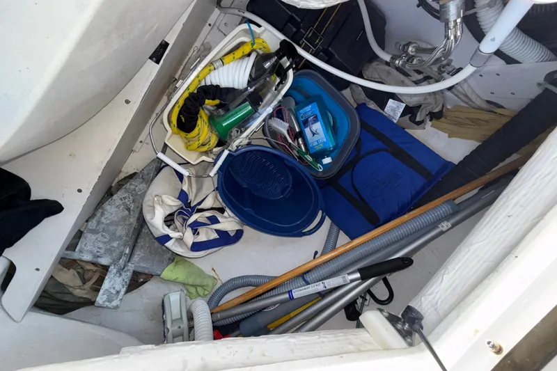 Slide: The Image of Storage compartment of a 2009 Sabre 386 boat with various marine equipment and supplies. - 91