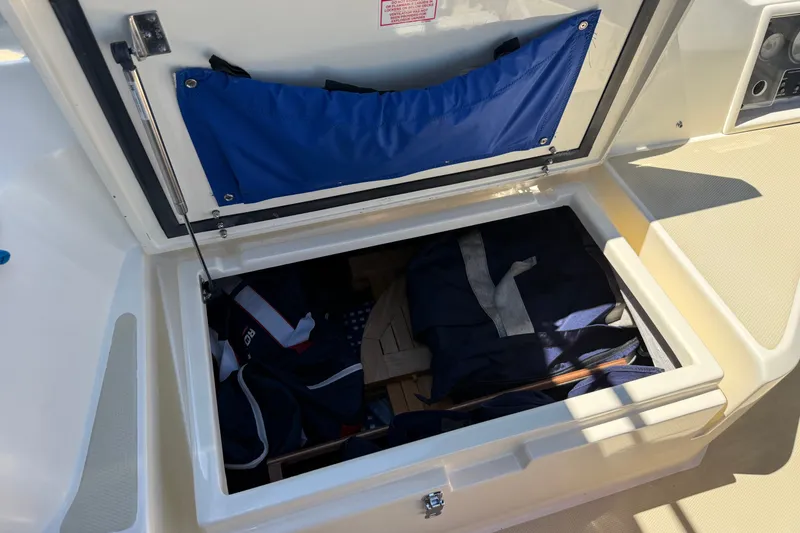 Slide: The Image of Storage compartment on a 2009 Sabre 386 boat, containing bags and equipment. - 85