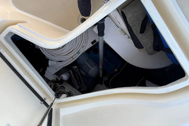 Slide: The Image of Open storage compartment on 2009 Sabre 386 boat, showing coiled hose and equipment. - 89