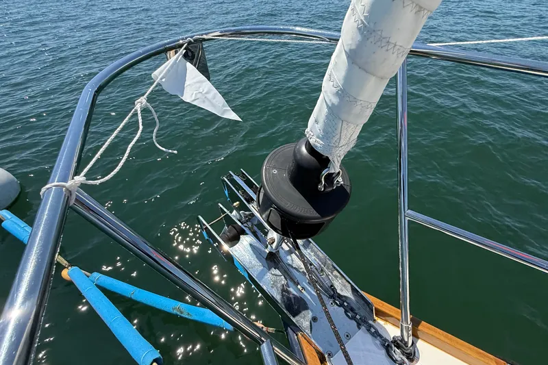 Slide: The Image of Bow of 2009 Sabre 386 sailboat with furled sail and calm water. - 67