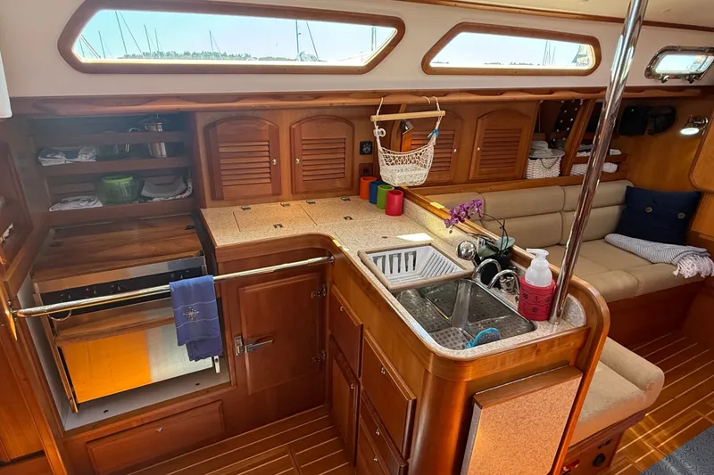 Slide: The Image of Luxurious 2009 Sabre 386 yacht interior with wooden cabinetry and cozy seating area. - 23