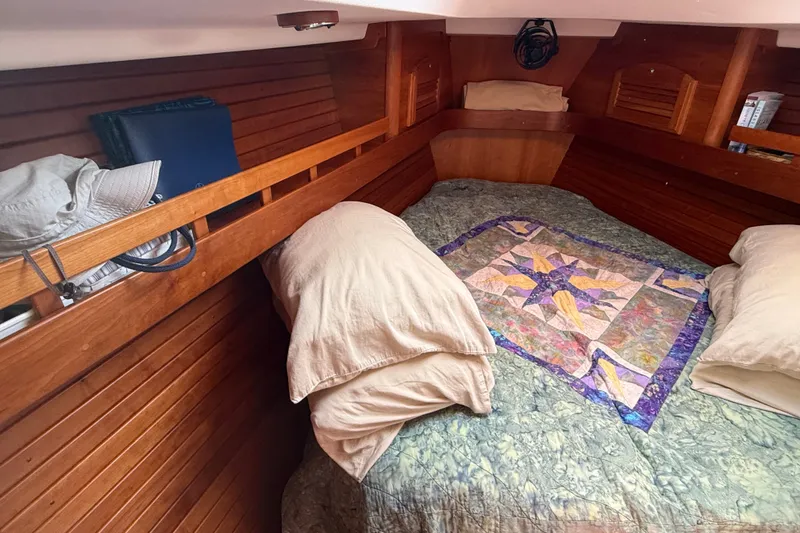 Slide: The Image of Cozy cabin interior of 2009 Sabre 386 sailboat with quilted bedding and wooden paneling. - 38