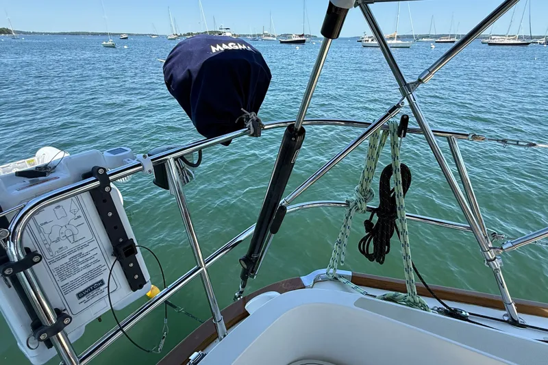 Slide: The Image of Sailboat deck view with equipment, ropes, and ocean backdrop; Sabre 386, 2009 model. - 87
