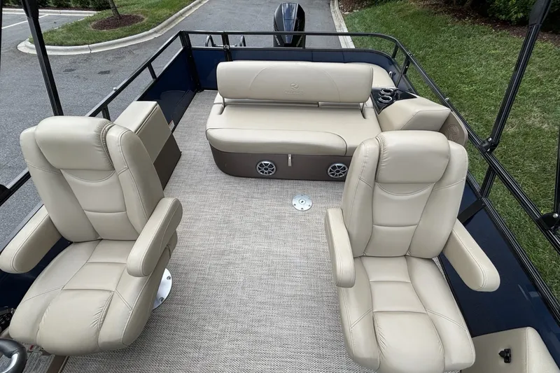 Slide: The Image of 2025 Regency 250DL3 pontoon boat interior with beige seating and modern design. - 20