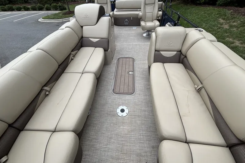 Slide: The Image of Luxurious seating on 2025 Regency 250DL3 pontoon boat, featuring beige upholstery and spacious layout. - 19