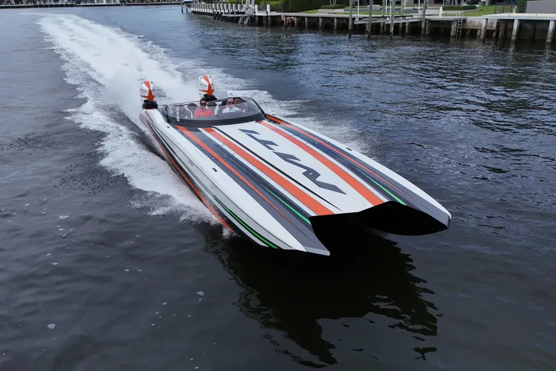 Slide: The Image of 2024 MTI 440X powerboat speeding on water, showcasing sleek design and vibrant stripes. - 4