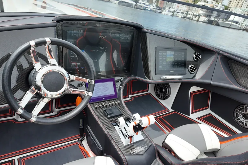Slide: The Image of Interior of 2024 MTI 440X boat with advanced dashboard and steering wheel. - 10