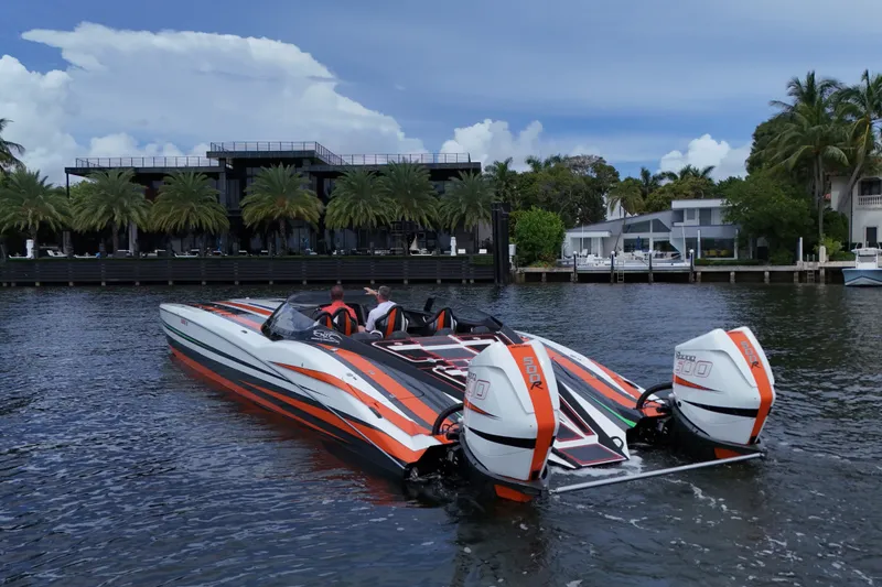 Slide: The Image of 2024 MTI 440X powerboat with dual engines on a scenic waterfront. - 8