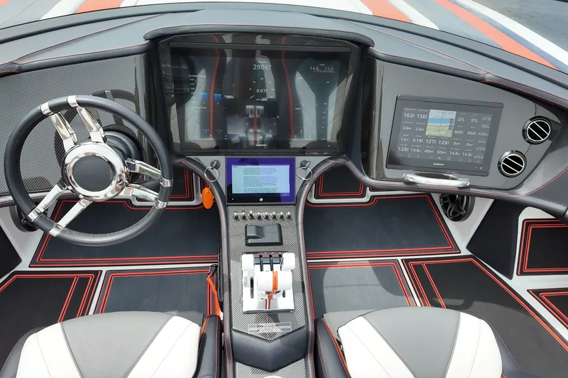 Slide: The Image of 2024 MTI 440X boat cockpit with advanced digital displays and sleek steering wheel design. - 12
