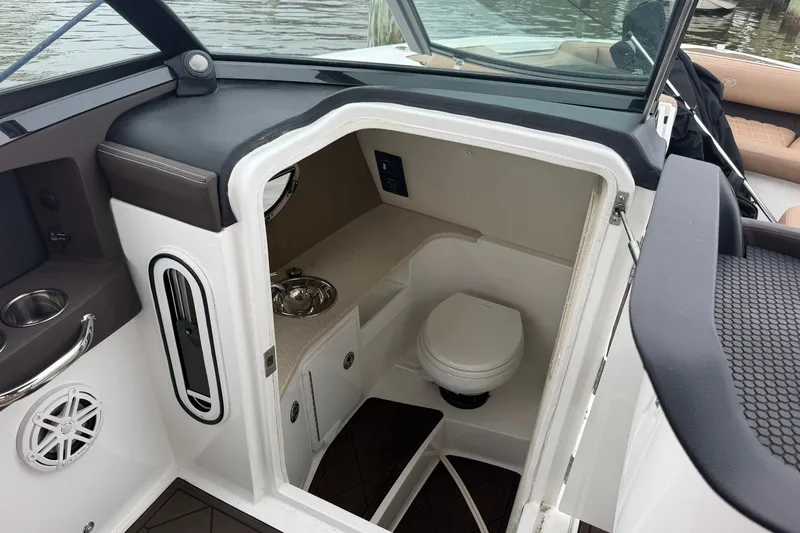 Slide: The Image of 2020 Cobalt 30SC boat interior with compact bathroom and sink. - 17