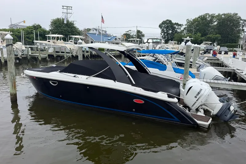 Slide: The Image of 2020 Cobalt 30SC boat docked at marina with Yamaha outboard engine. - 2