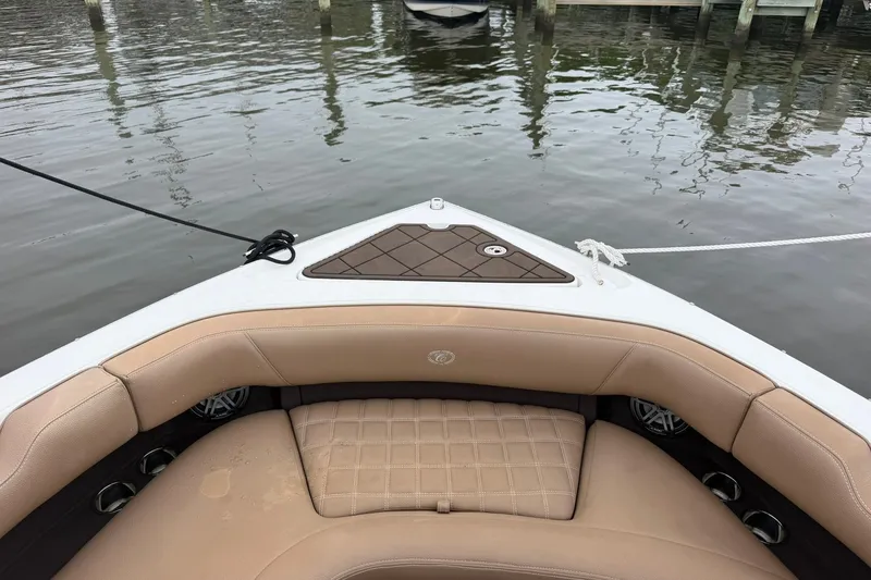 Slide: The Image of Bow seating area of a 2020 Cobalt 30SC boat with tan upholstery. - 5
