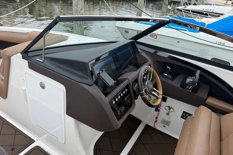 Slide: The Image of 2020 Cobalt 30SC boat cockpit with modern steering and control panel. - 12