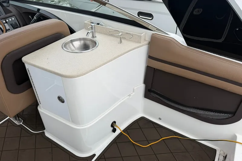 Slide: The Image of Interior of a 2020 Cobalt 30SC boat featuring a compact sink and seating area. - 14