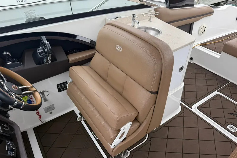 Slide: The Image of 2020 Cobalt 30SC boat interior with tan seating and steering wheel. - 13